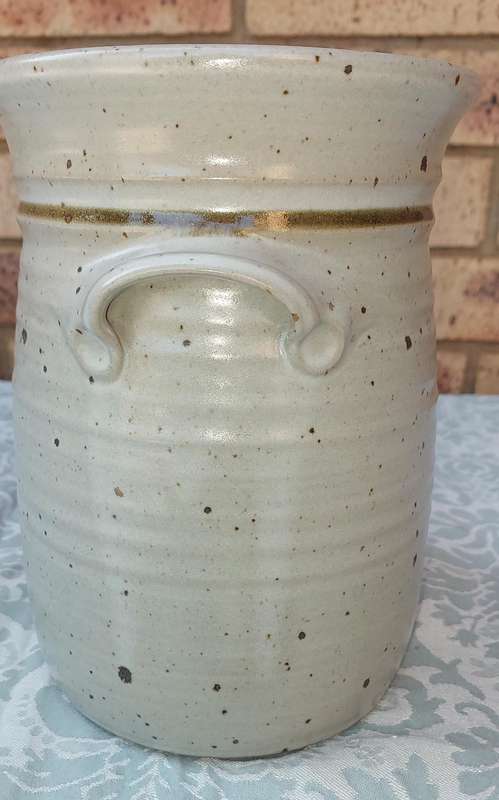 A CERAMIC POTTERY OLIVE JAR WITH A LID SOLD AS IS