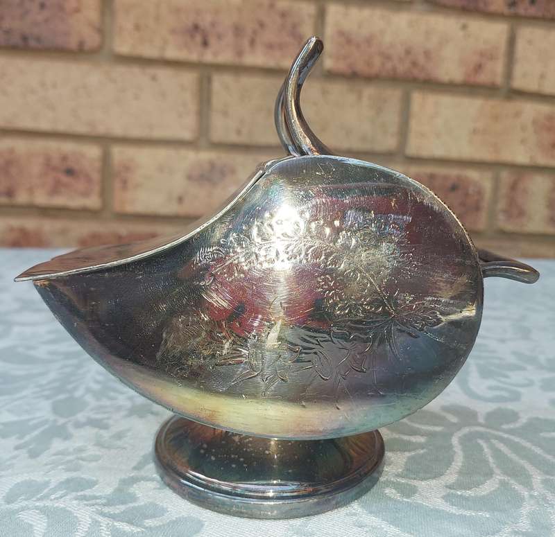 AN ORNATE SILVER PLATE SUGAR SCUTTLE MADE IN SHEFFIELD ENGLAND