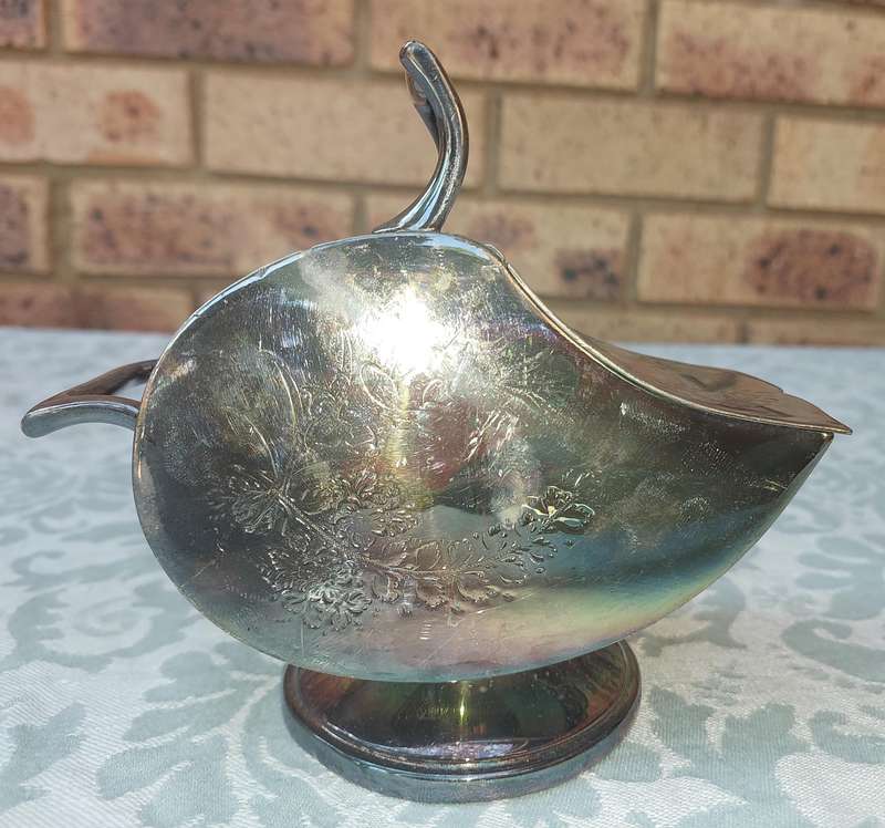 AN ORNATE SILVER PLATE SUGAR SCUTTLE MADE IN SHEFFIELD ENGLAND