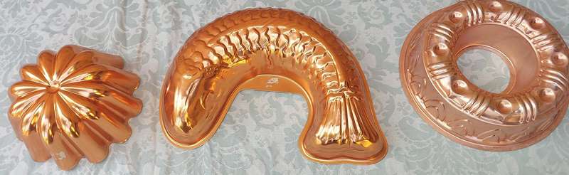 A COLLECTION OIF COPPER BAKING DISHES SOLD AS IS