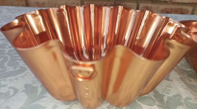 A COLLECTION OIF COPPER BAKING DISHES SOLD AS IS