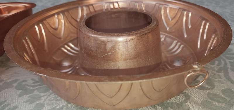 A COLLECTION OIF COPPER BAKING DISHES SOLD AS IS