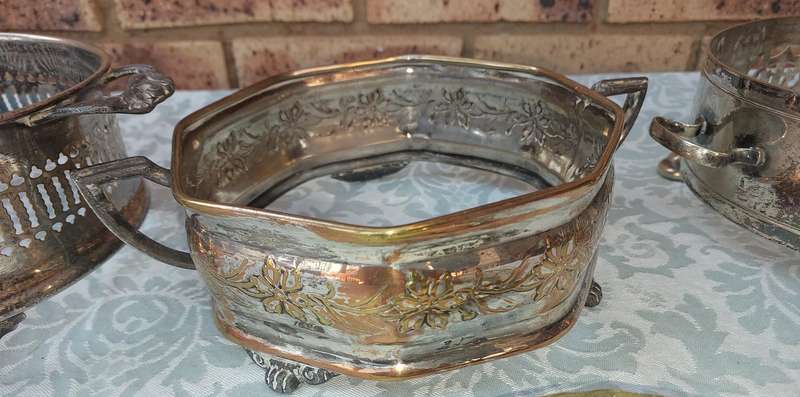 A COLLECTION OF VINTAGE SILVER PLATED CADDY BASKETS SOLD AS IS