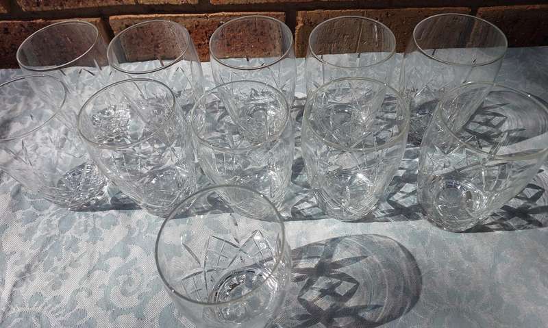 A SET OF 11 CRYSTAL GLASSES SOLD AS IS