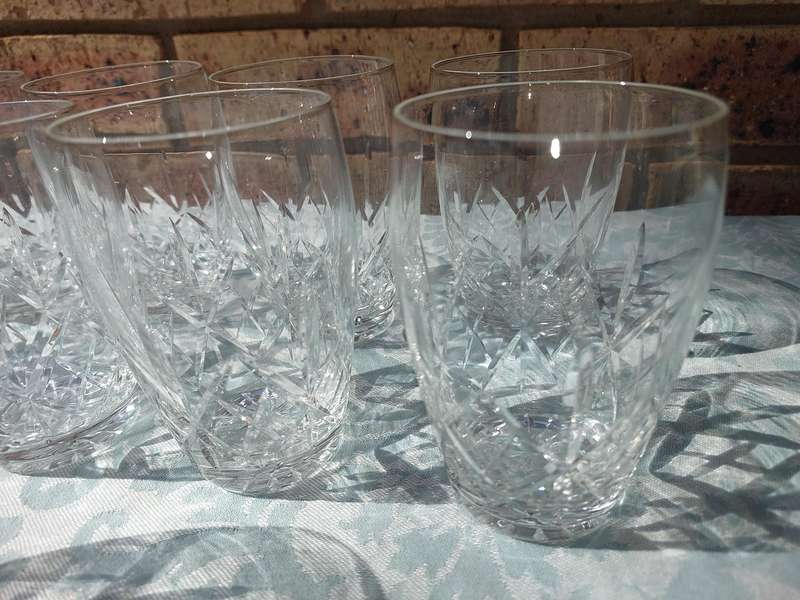 A SET OF 11 CRYSTAL GLASSES SOLD AS IS