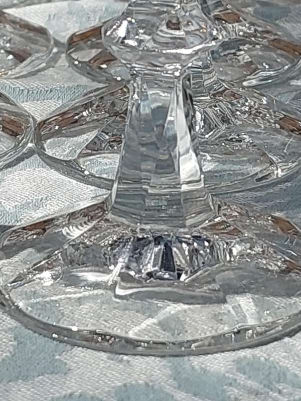 A SET OF 12 CRYSTAL WINE GLASSES WITH STEMS SOLD AS IS
