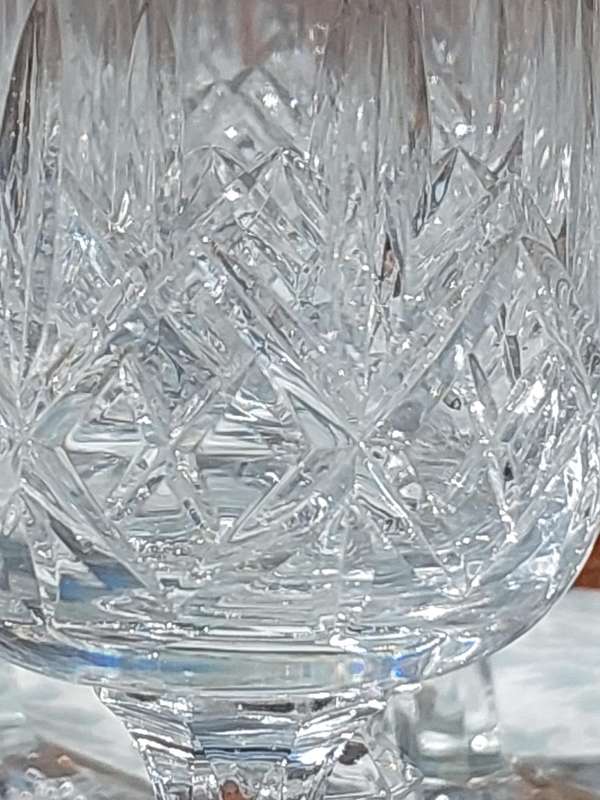 A SET OF 12 CRYSTAL WINE GLASSES WITH STEMS SOLD AS IS