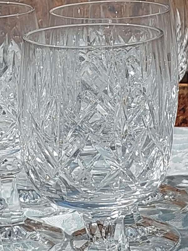 A SET OF 12 CRYSTAL WINE GLASSES WITH STEMS SOLD AS IS