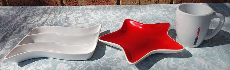 A COLLECTION OF PORCELAIN SERVING PLATTERS AND A COFFEE MUG SOLD AS IS