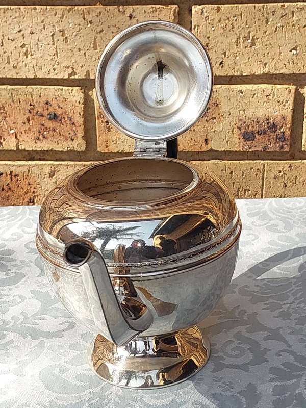 A VINTAGE SILVER PLATED TEAPOT SOLD AS IS