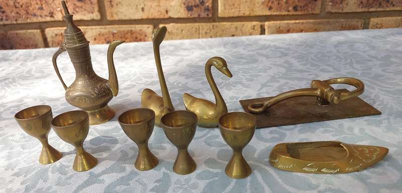 A COLLECTION OF BRASS FIGURINES AND UTENSILS SOLD AS IS
