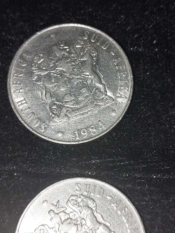 A COLLECTION OF 10 VINTAGE  SOUTH AFRICAN 50 CENTS COINS SOLD AS IS