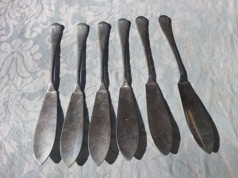 AN ANTIQUE SET OF ATLAS NICKLE SILVER FISH KNIVES SOLD AS IS