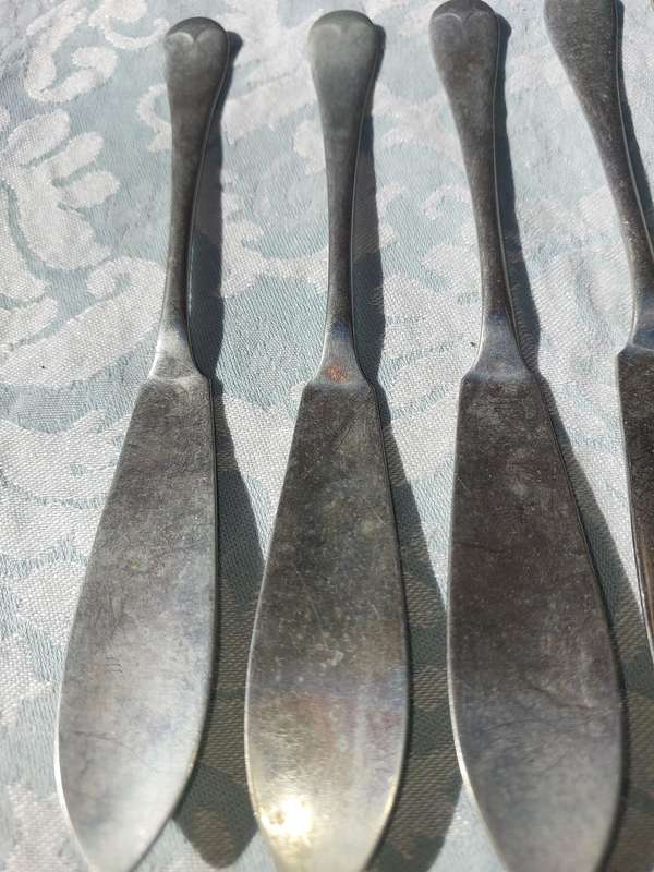 AN ANTIQUE SET OF ATLAS NICKLE SILVER FISH KNIVES SOLD AS IS