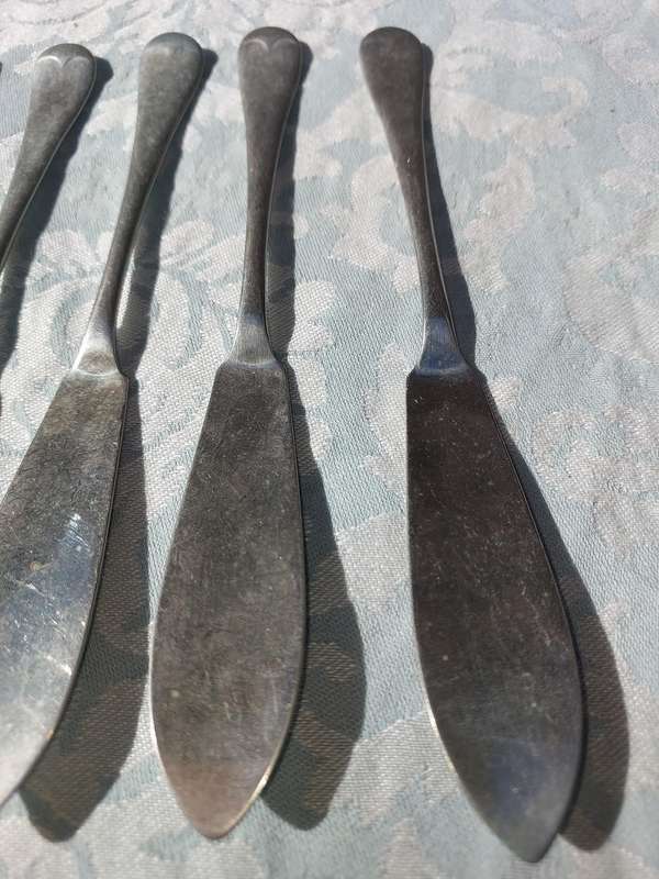 AN ANTIQUE SET OF ATLAS NICKLE SILVER FISH KNIVES SOLD AS IS