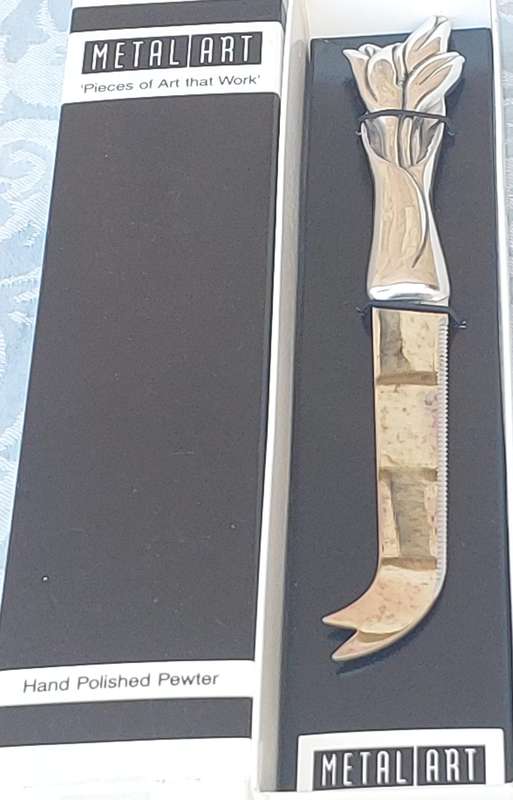 A METAL ART POLISHED PEWTER CHEESE CUTTER SOLD AS IS