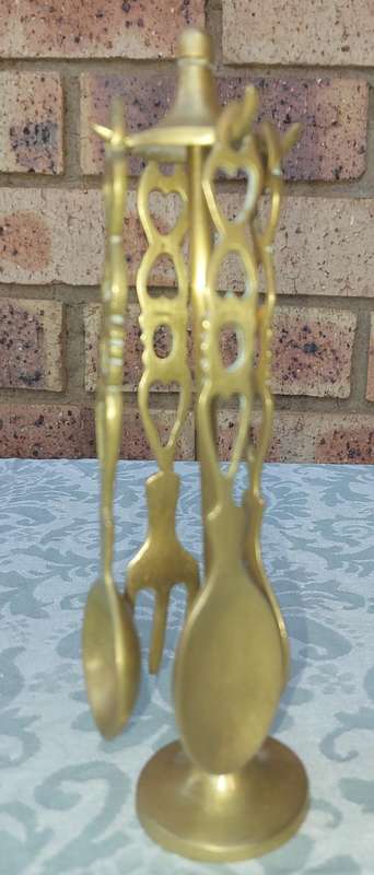 AN ART DECOR BRASS STAND WITH CUTLERY SOLD AS IS