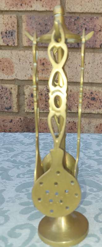 AN ART DECOR BRASS STAND WITH CUTLERY SOLD AS IS