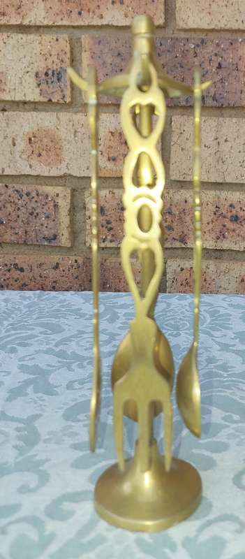 AN ART DECOR BRASS STAND WITH CUTLERY SOLD AS IS