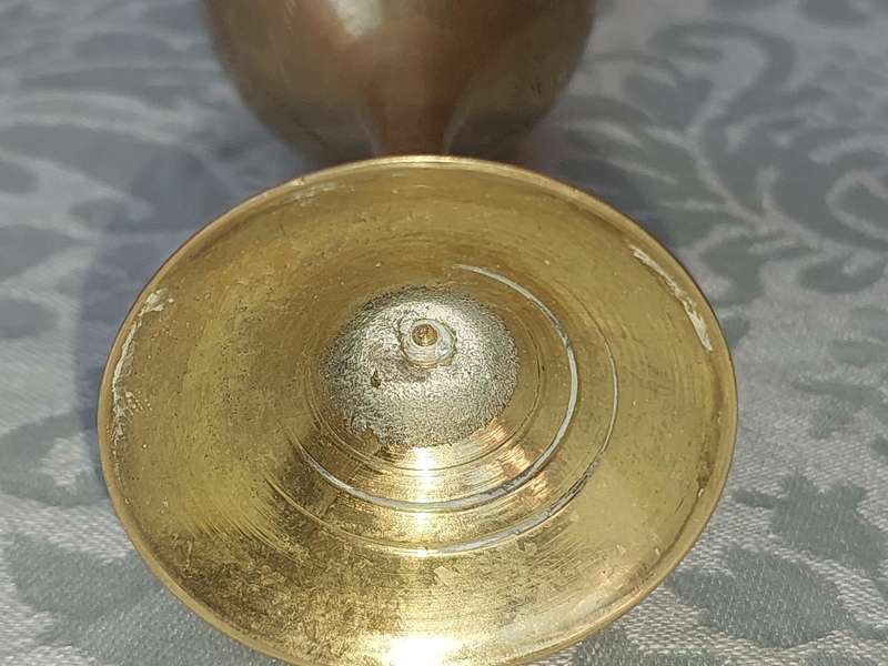 A VINTAGE BRASS VASE AND A BELL SOLD AS IS