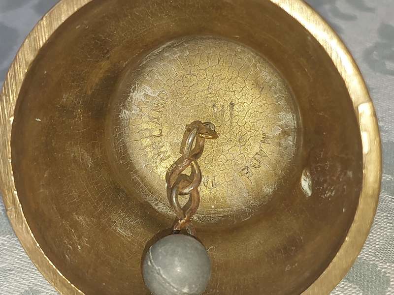 A VINTAGE BRASS VASE AND A BELL SOLD AS IS