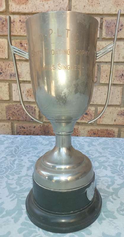 A VINTAGE TENNIS CHAMPIONS FLAOTING TROPHY SOLD AS IS