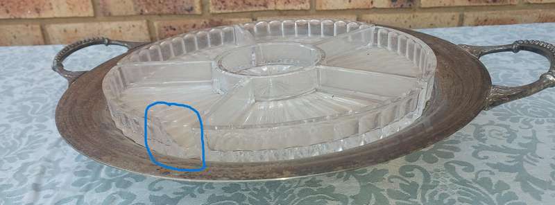 AN ANTIQUE SILVER PLATED WITH HANDLES LAZY SUZAN WITH ONE OF THE GLASS SEGMENT CRACKED SOLD AS IS