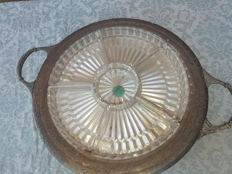 AN ANTIQUE SILVER PLATED WITH HANDLES LAZY SUZAN WITH ONE OF THE GLASS SEGMENT CRACKED SOLD AS IS