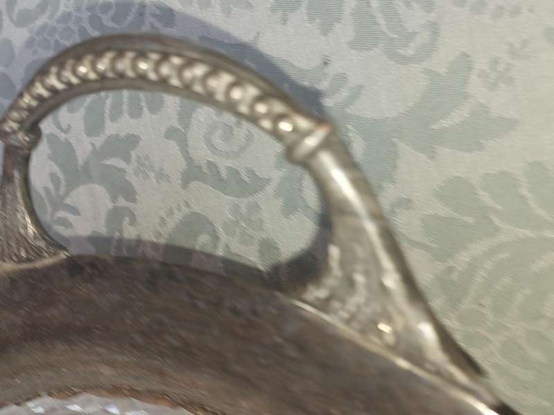 AN ANTIQUE SILVER PLATED WITH HANDLES LAZY SUZAN WITH ONE OF THE GLASS SEGMENT CRACKED SOLD AS IS