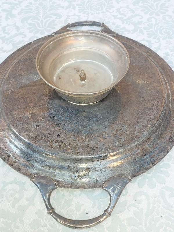 AN ANTIQUE SILVER PLATED WITH HANDLES LAZY SUZAN WITH ONE OF THE GLASS SEGMENT CRACKED SOLD AS IS