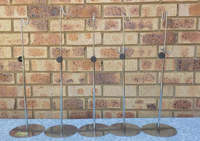 A COLLECTION OF 5 STAINLESS STEEL TABLE STANDS SOLD AS IS