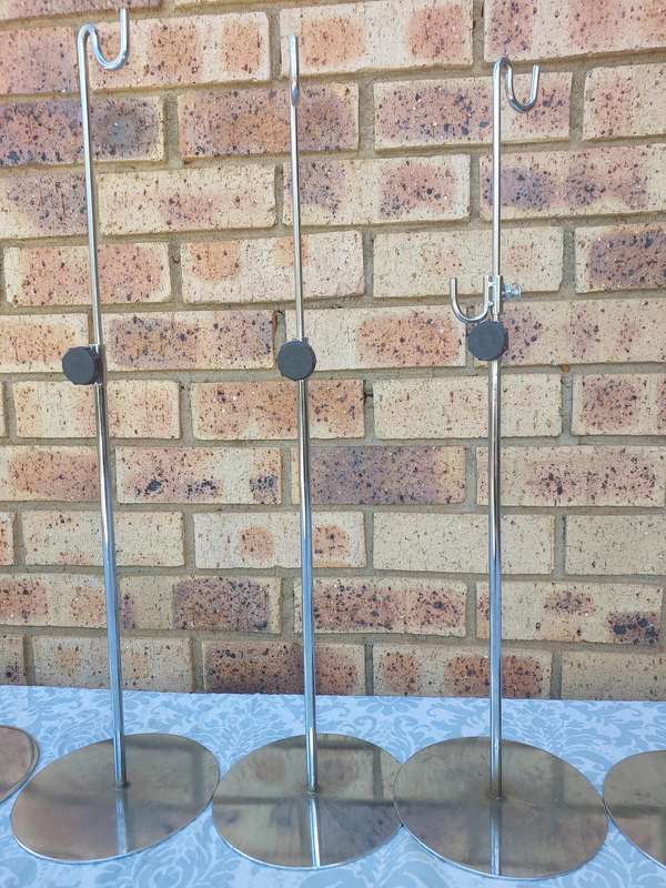 A COLLECTION OF 5 STAINLESS STEEL TABLE STANDS SOLD AS IS