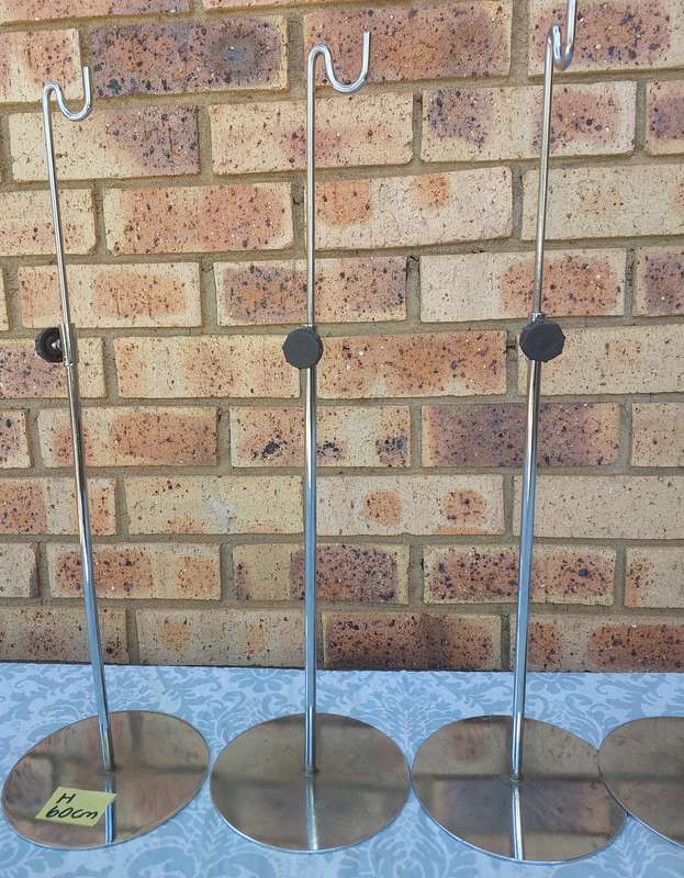 A COLLECTION OF 5 STAINLESS STEEL TABLE STANDS SOLD AS IS