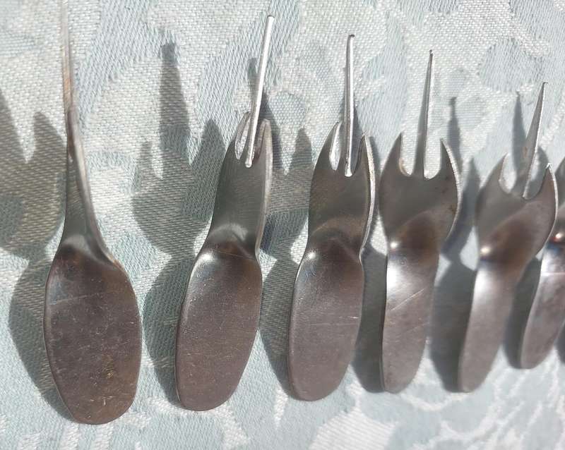 A COLLECTION STAINLESS STEEL CORN ON THE COB HOLDERS SOLD AS IS