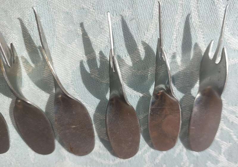 A COLLECTION STAINLESS STEEL CORN ON THE COB HOLDERS SOLD AS IS