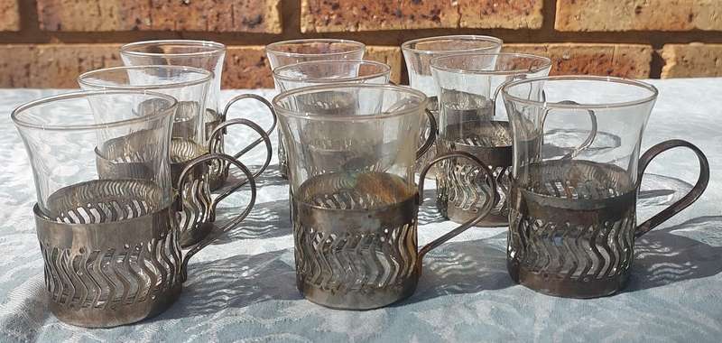 A SET OF 9 PERSIAN TEA GLASSES SOLD AS IS