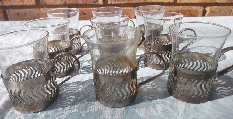 A SET OF 9 PERSIAN TEA GLASSES SOLD AS IS