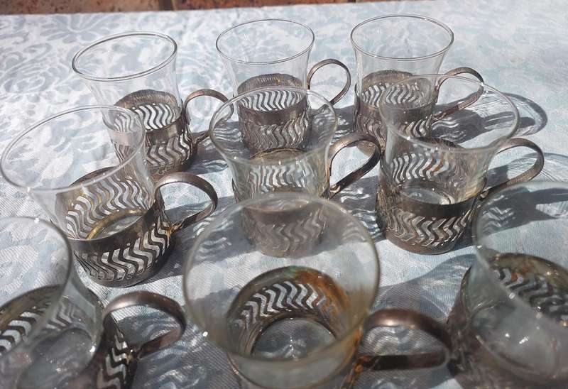A SET OF 9 PERSIAN TEA GLASSES SOLD AS IS