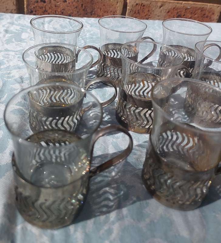 A SET OF 9 PERSIAN TEA GLASSES SOLD AS IS