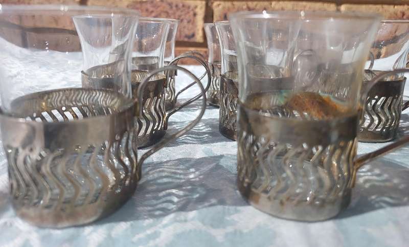 A SET OF 9 PERSIAN TEA GLASSES SOLD AS IS
