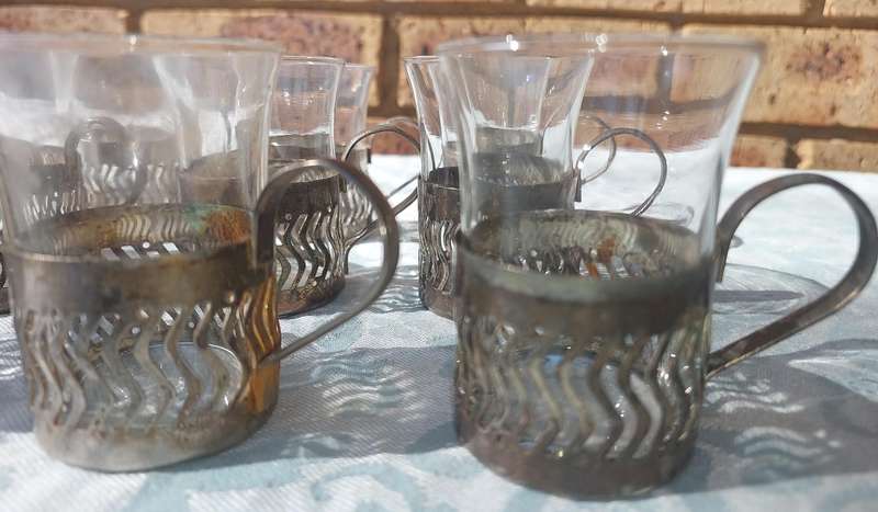 A SET OF 9 PERSIAN TEA GLASSES SOLD AS IS