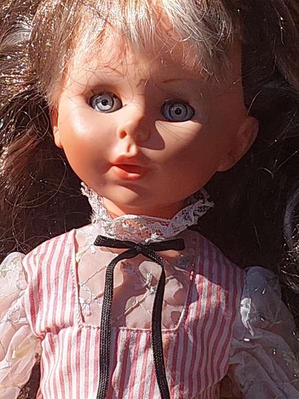 A VINTAGE DOLL SOLD AS IS