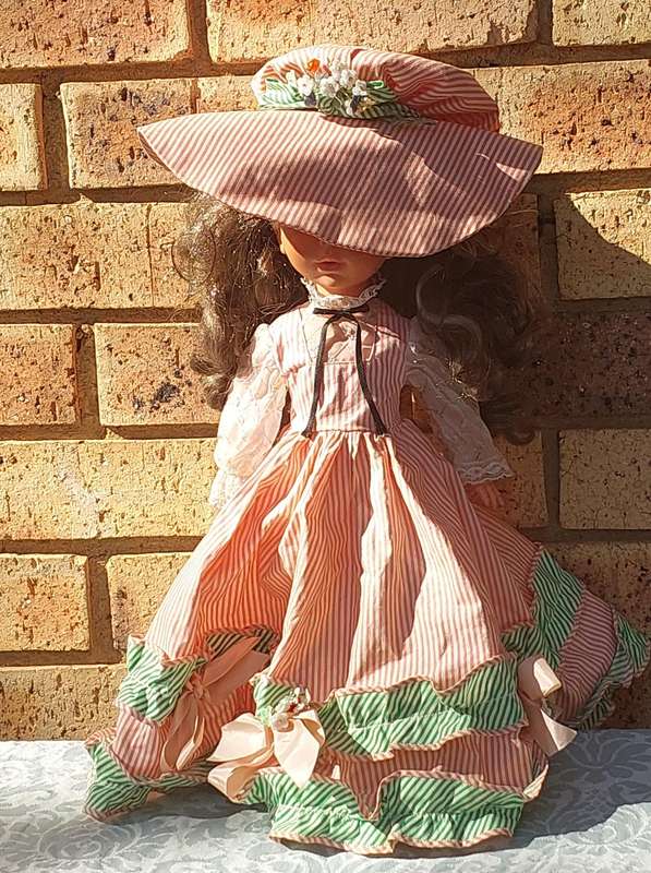 A VINTAGE DOLL SOLD AS IS