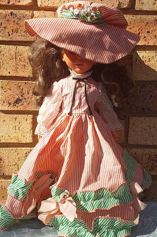A VINTAGE DOLL SOLD AS IS