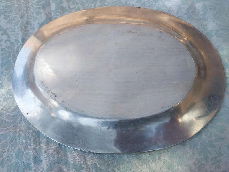 A VINTAGE HAND MADE PEWTEL OVAL SERVING PLATTER SOLD AS IS