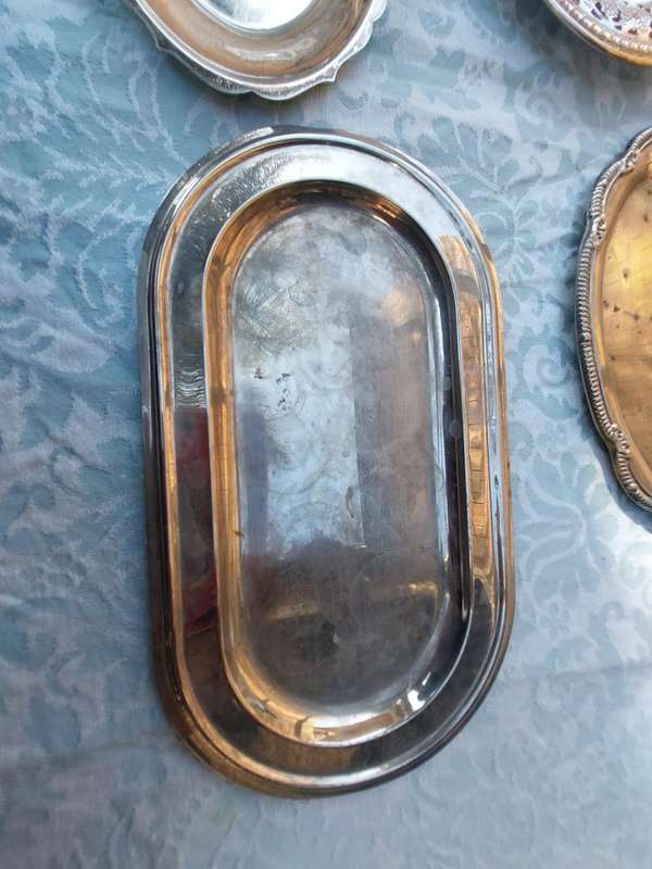 A COLLECTION OF SILVER PLATED SERVING TRAYS SOLD AS IS