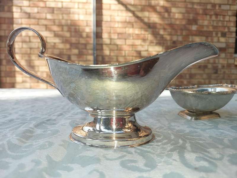 TWO VINTAGE UTENSILS A SAUCE BOAT AND A BUTTER DISH SOLD AS IS