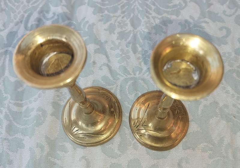 A SET OF ORNATE BRASS CANDLE HOLDERS SOLD AS IS