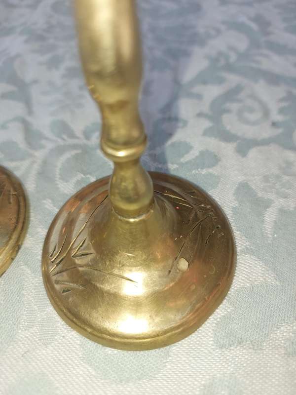 A SET OF ORNATE BRASS CANDLE HOLDERS SOLD AS IS