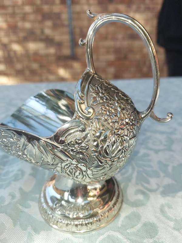 A VINTAGE SILVERPLATED SUGAR SCUTTLE SOLD AS IS